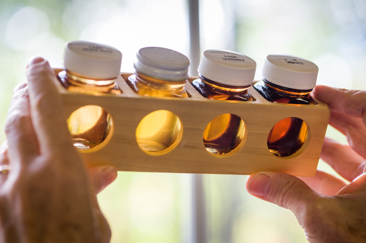 four small maple syrup bottles