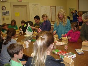 4 Leaf Clover Club members decorating gingerbread houses