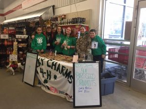 Lucky Charms 4-H Club members at a fundraising event, selling birdseed ornaments at Tractor Supply, Inc.