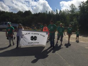 4-Leaf Clover Club members marching in a parade.