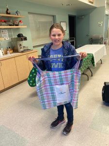 Girl holds handmade tote bag