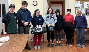 Four 4-H'ers and their Leader with Shapleigh EMT's learning about AED and Emergency Response