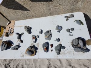 Faces formed with Rocks that the Beachcombers 4-H club collected.
