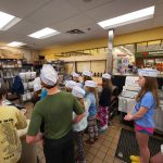 Group photo of Nature Kids 4-H Club at Hannaford Supermarkets listening to their tour guide