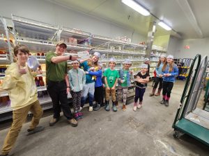 Group photo of Nature Kids 4-H Club at Hannaford Supermarkets in the Milk/ Dairy Coolers
