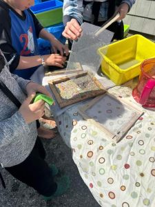 Beachcombers made recycled paper at the beach and added bits of treasures and sand to the paper.